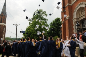 Graduates toss their caps in the air! 